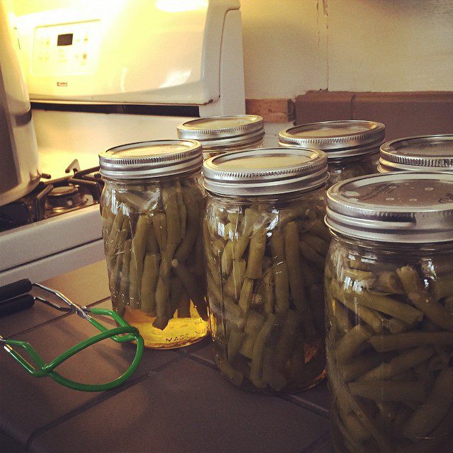 Green beans canning in glass mason jars