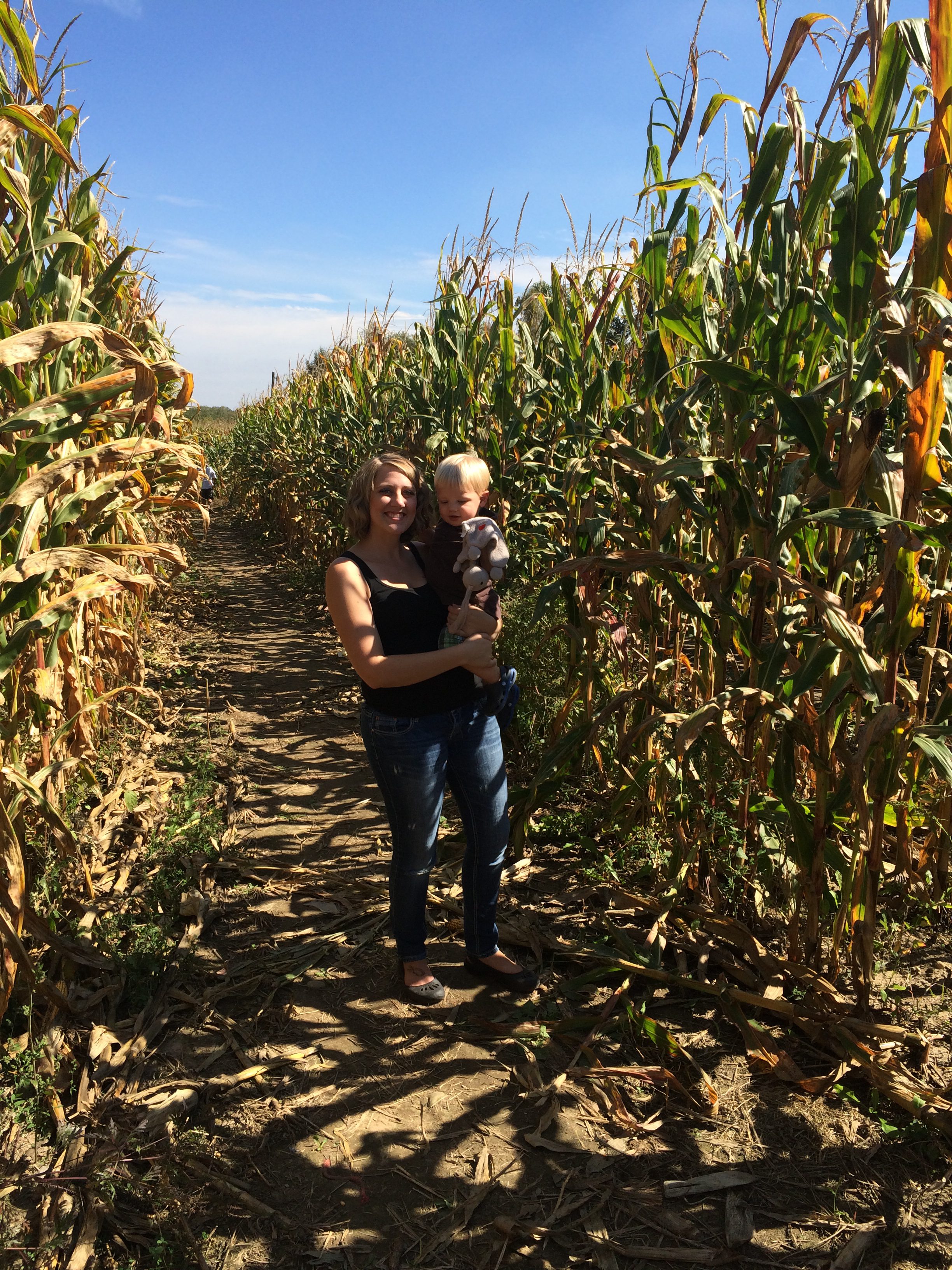 Audrey and Liam standing a field of corn