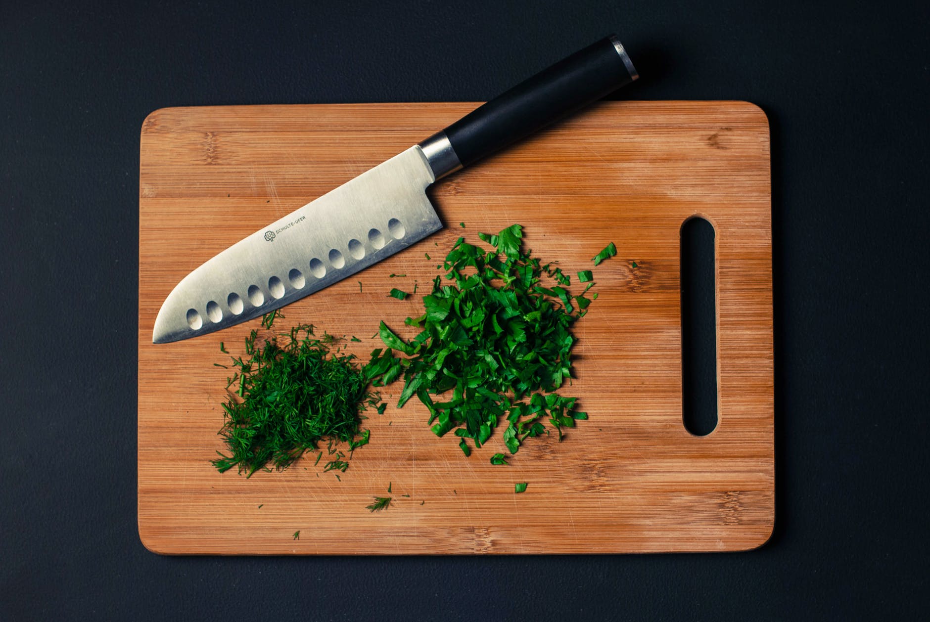food-vegetables-wood-knife herbs chopped