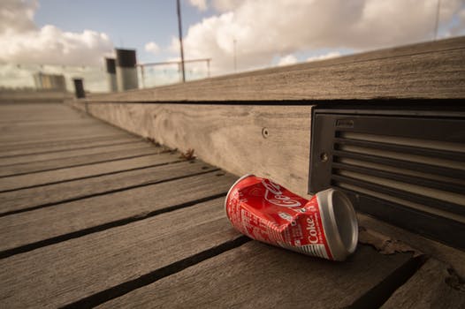 Litter cola can crunched on ship dock