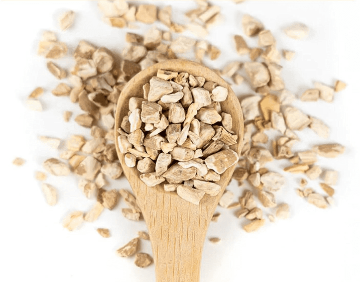 A wooden spoon filled with dried, crushed roots arranged on a white background. Happy Tea: Uplifting Herbs for the Winter Blues