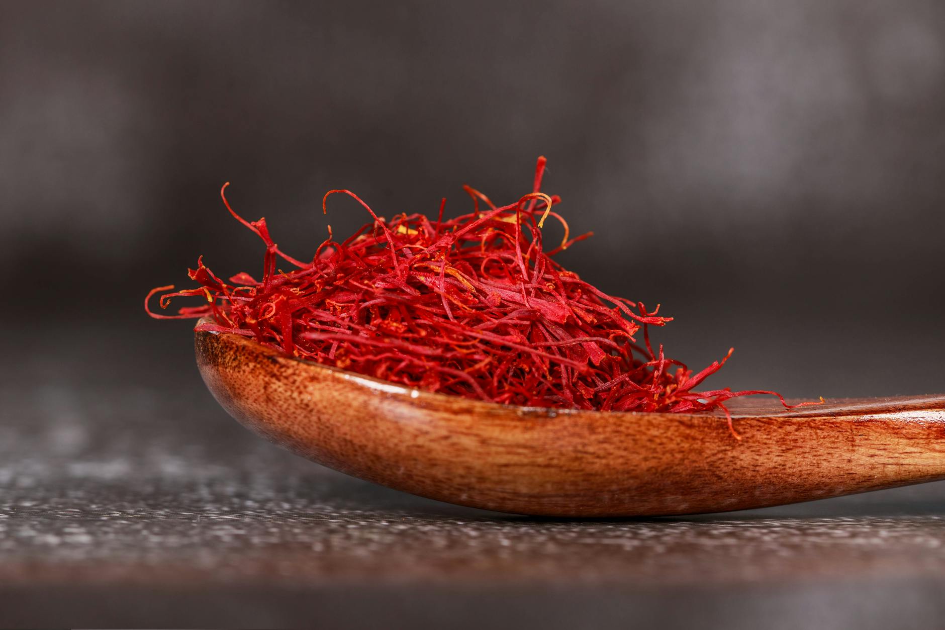 red saffron spice on brown wooden spoon Happy Tea: Uplifting Herbs for the Winter Blues