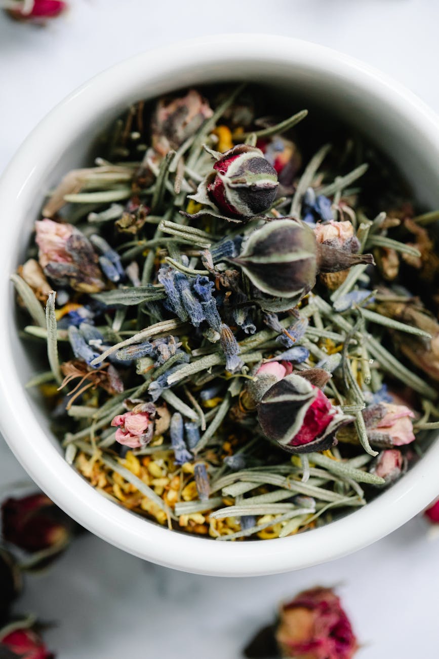 mixture of herbs and dried blossom in ceramic bowl Happy Tea: Uplifting Herbs for the Winter Blues
