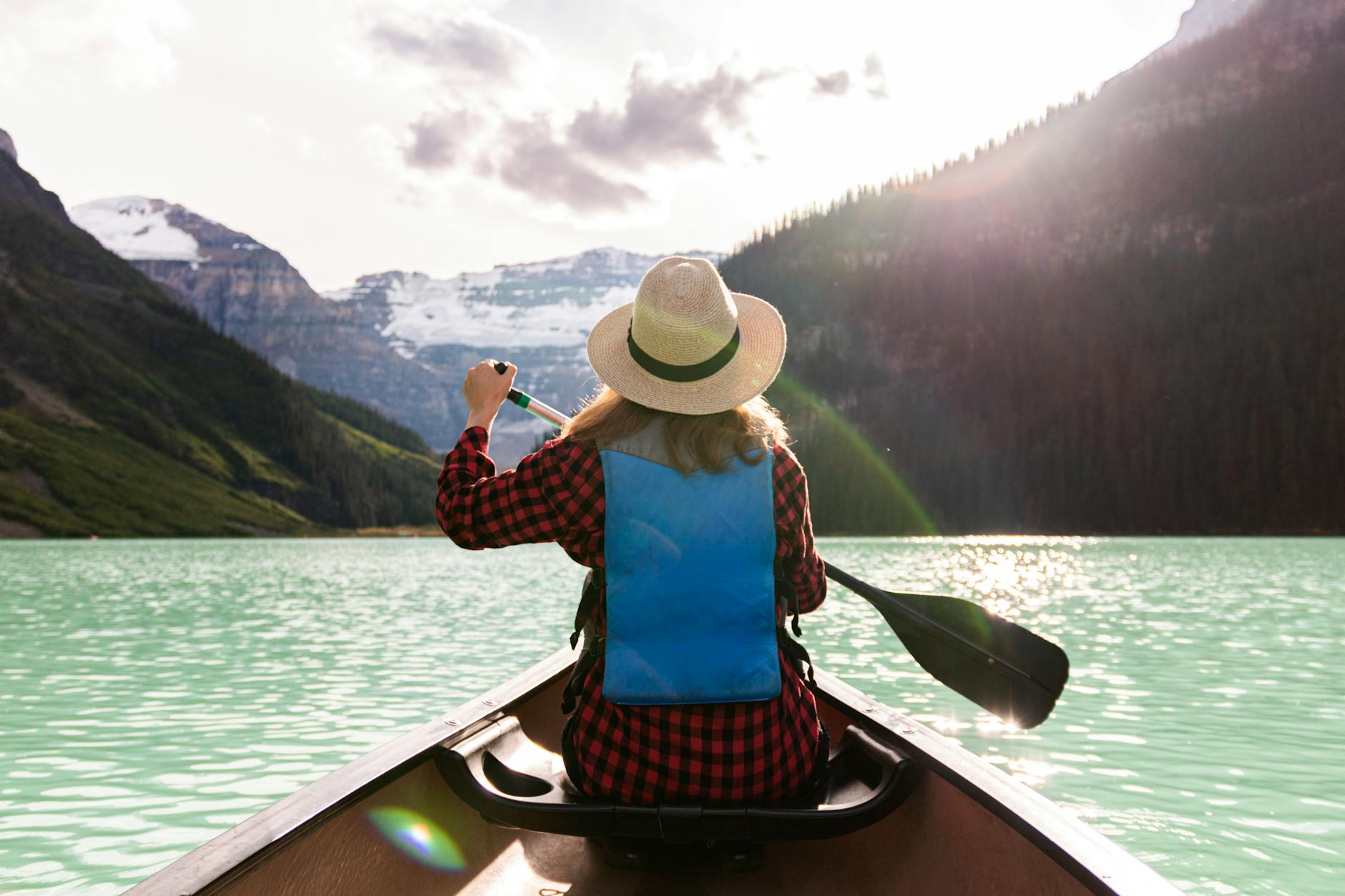 a woman paddling a boat in the lake Blog Article Categories Travel