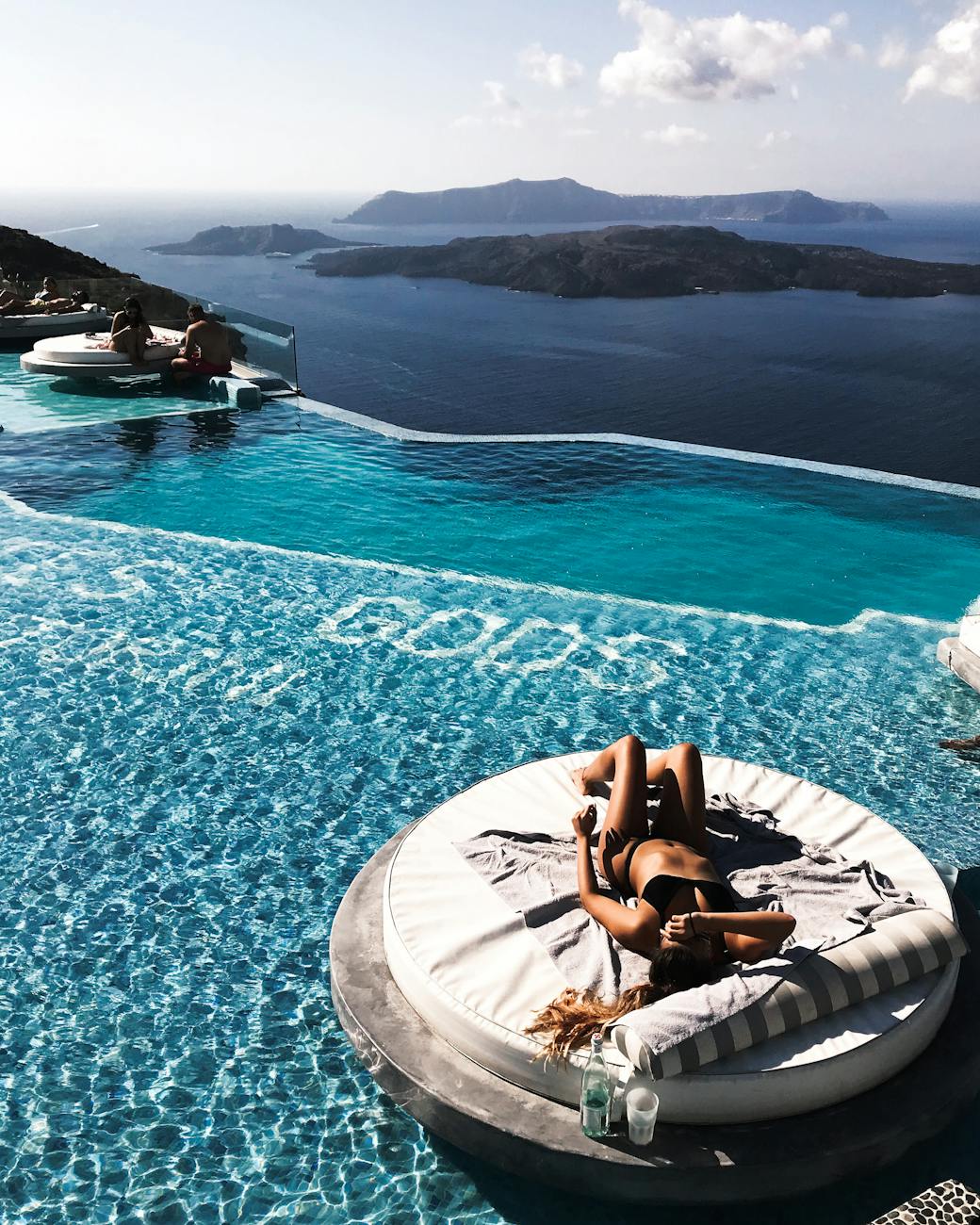 woman lying down in swimming pool in holiday resort Romantic Getaway Ideas to Rekindle Your Love