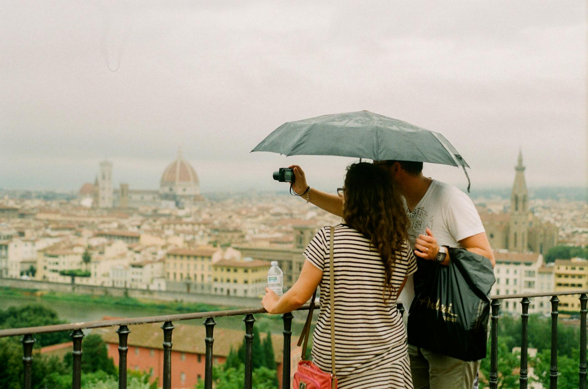 two people taking photo of city Romantic Getaway Ideas to Rekindle Your Love