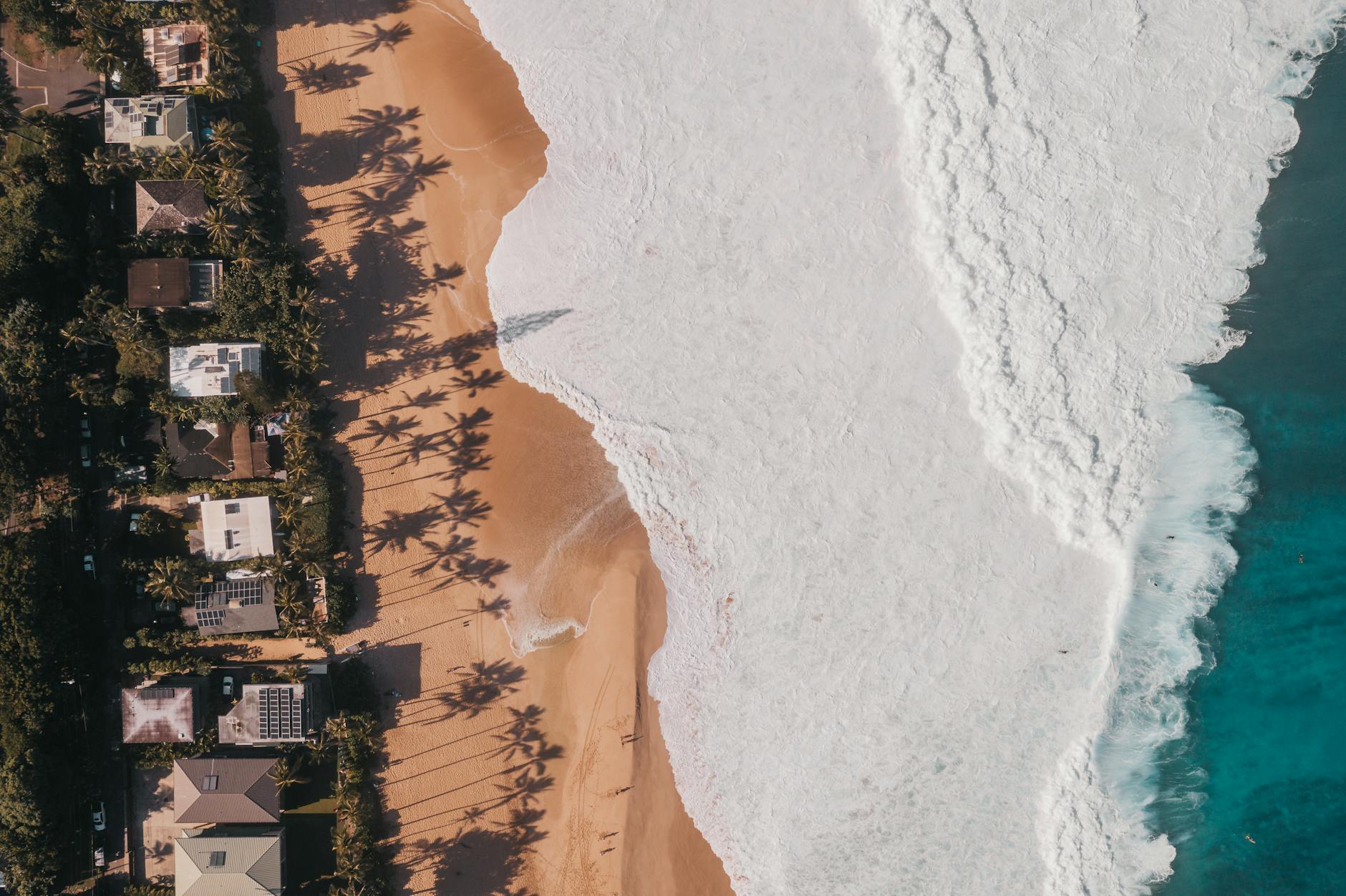 10 Ways to Prep Your Vacation Rental Property for Guests 15 aerial photography of waves crashing to the sandy shore of a beach 10 Ways to Prep Your Vacation Rental Property for Guests