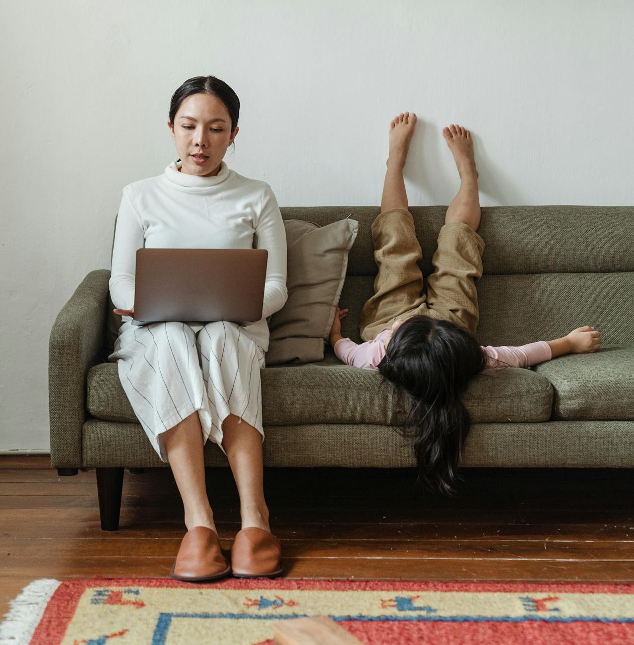 photo of mother working at home Upgrade Your Zoom Meetings with an Eye-Catching Virtual Background