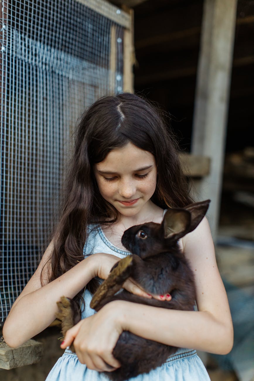 How to Teach Frontier Children Confidence 9 girl in blue denim dress carrying a rabbit
