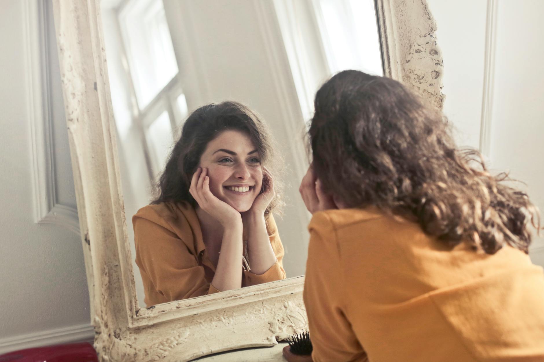 photo of woman looking at the mirror self confidence