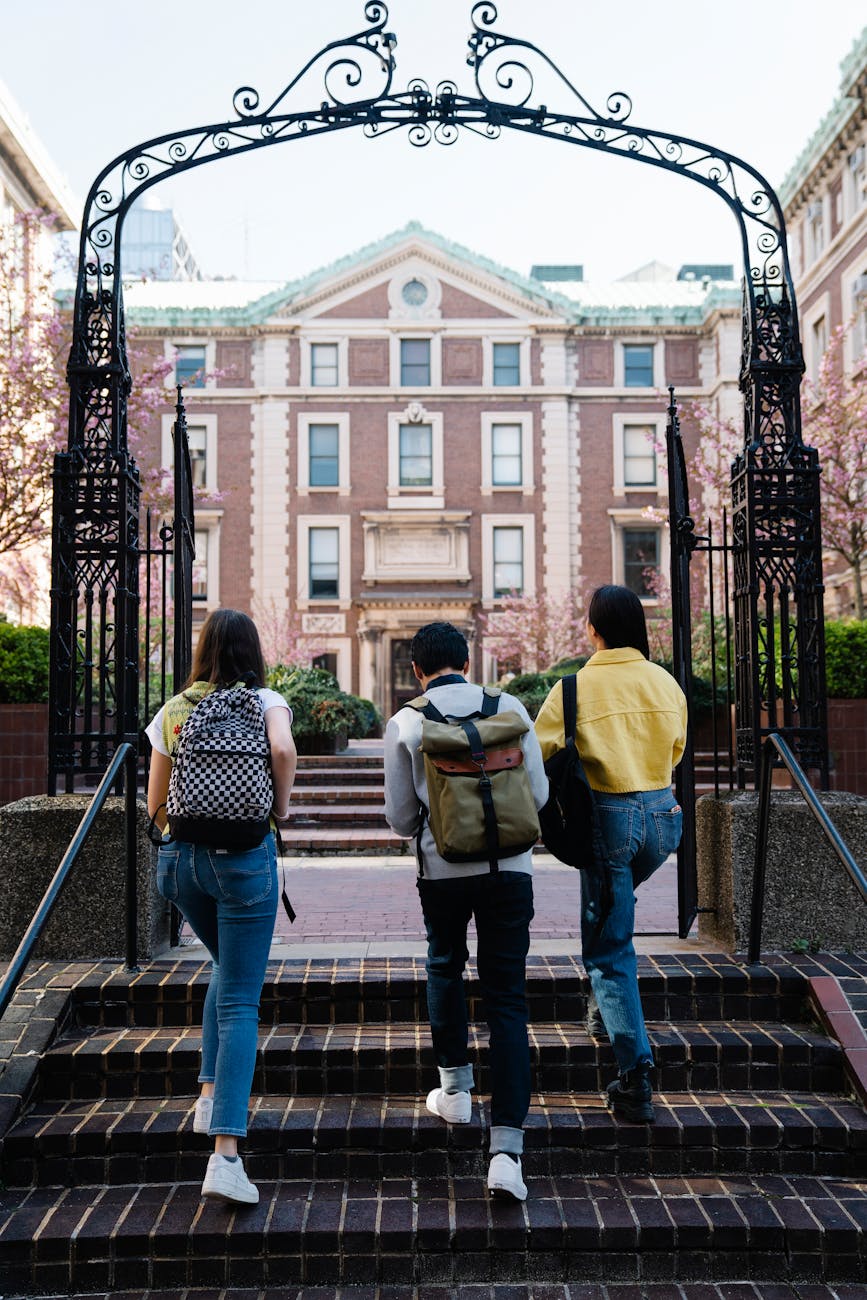 back view of people walking into a campus Getting Your Child Through College: Important Financial Considerations