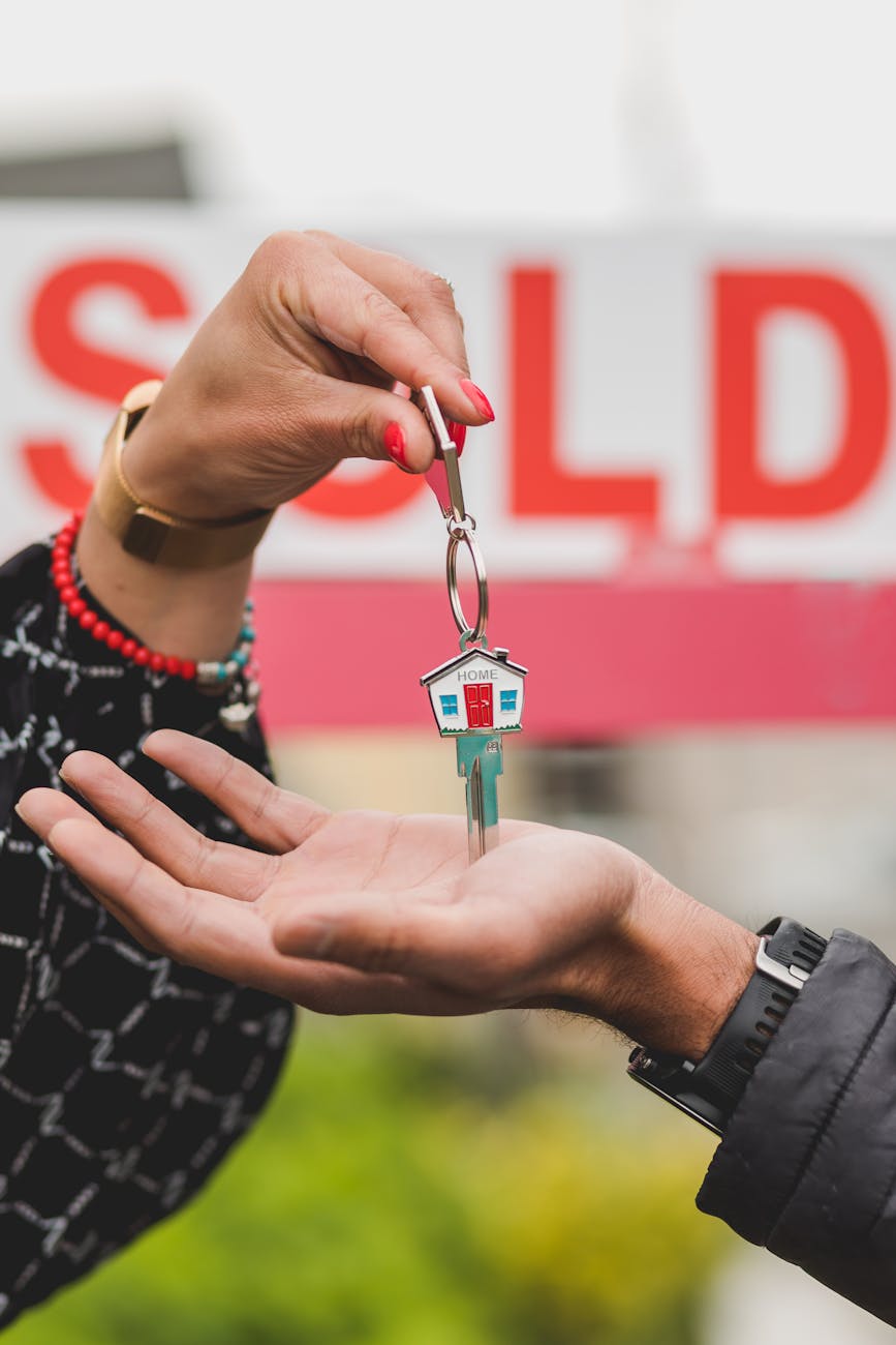 person handing out a house key 6 strategies to sell your home fast