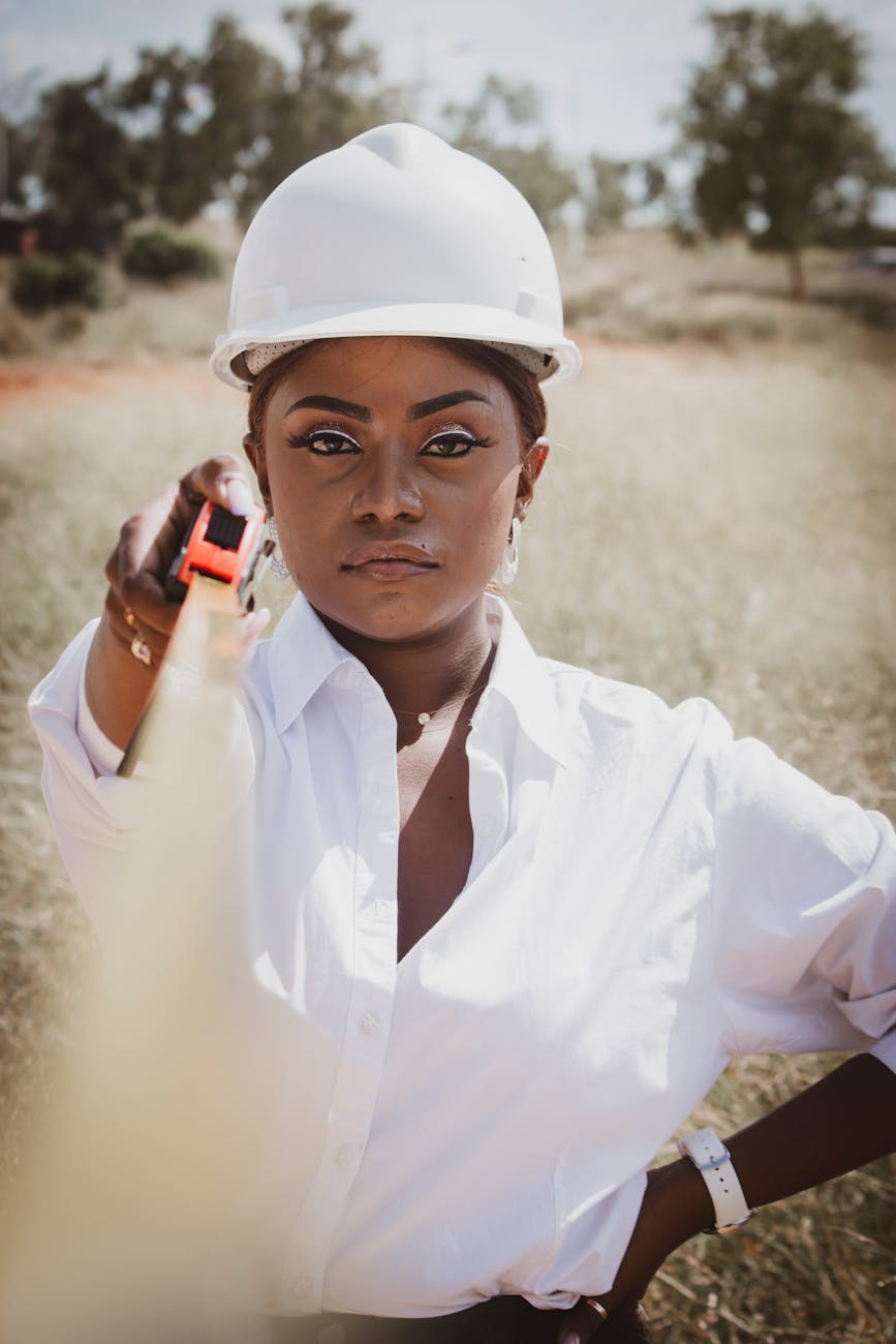 woman holding a tape measure Why Building Your Own Home Is Achievable and Affordable
