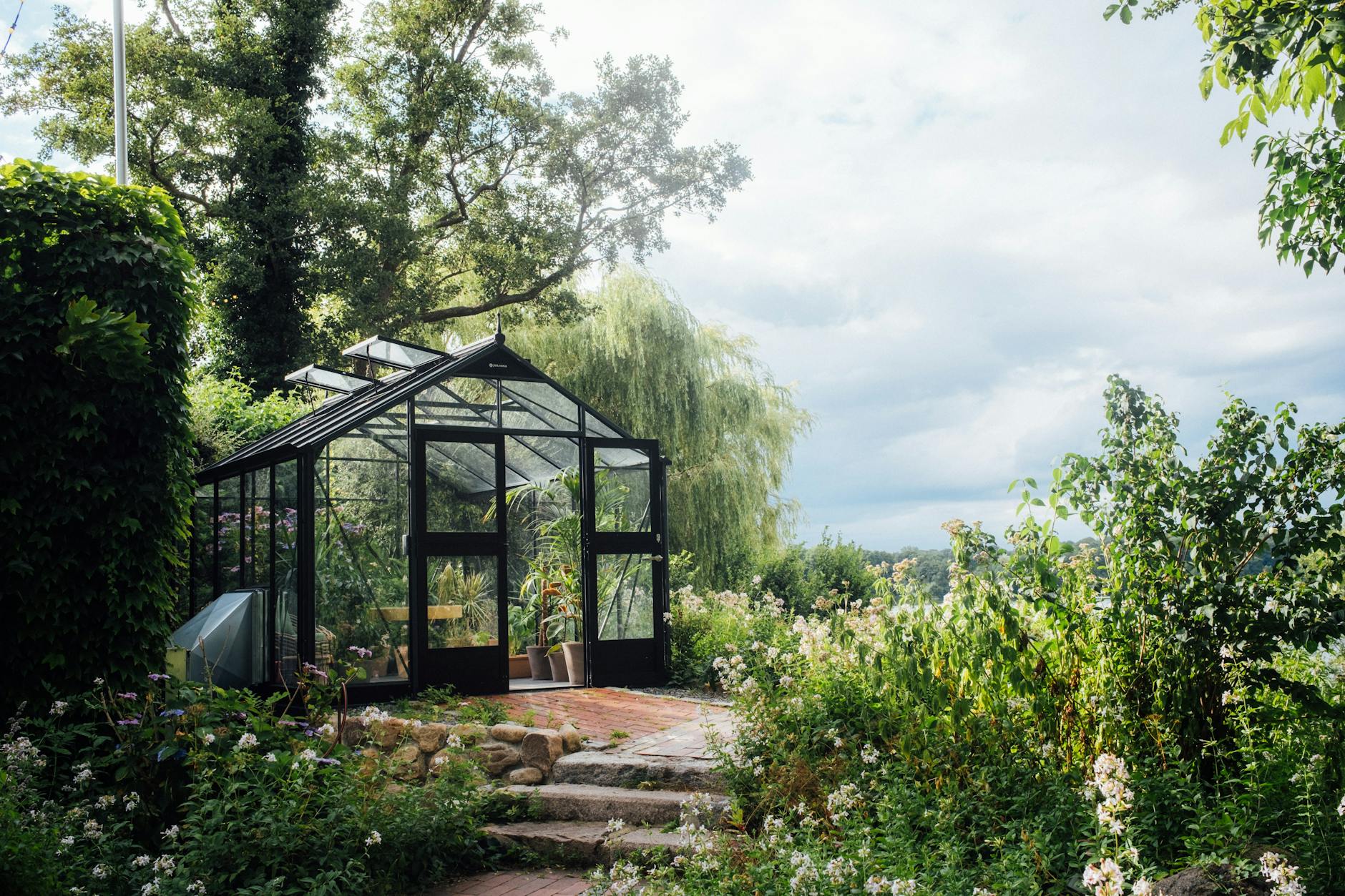 a greenhouse in a garden The Ultimate Guide to Indoor/Outdoor Living Spaces