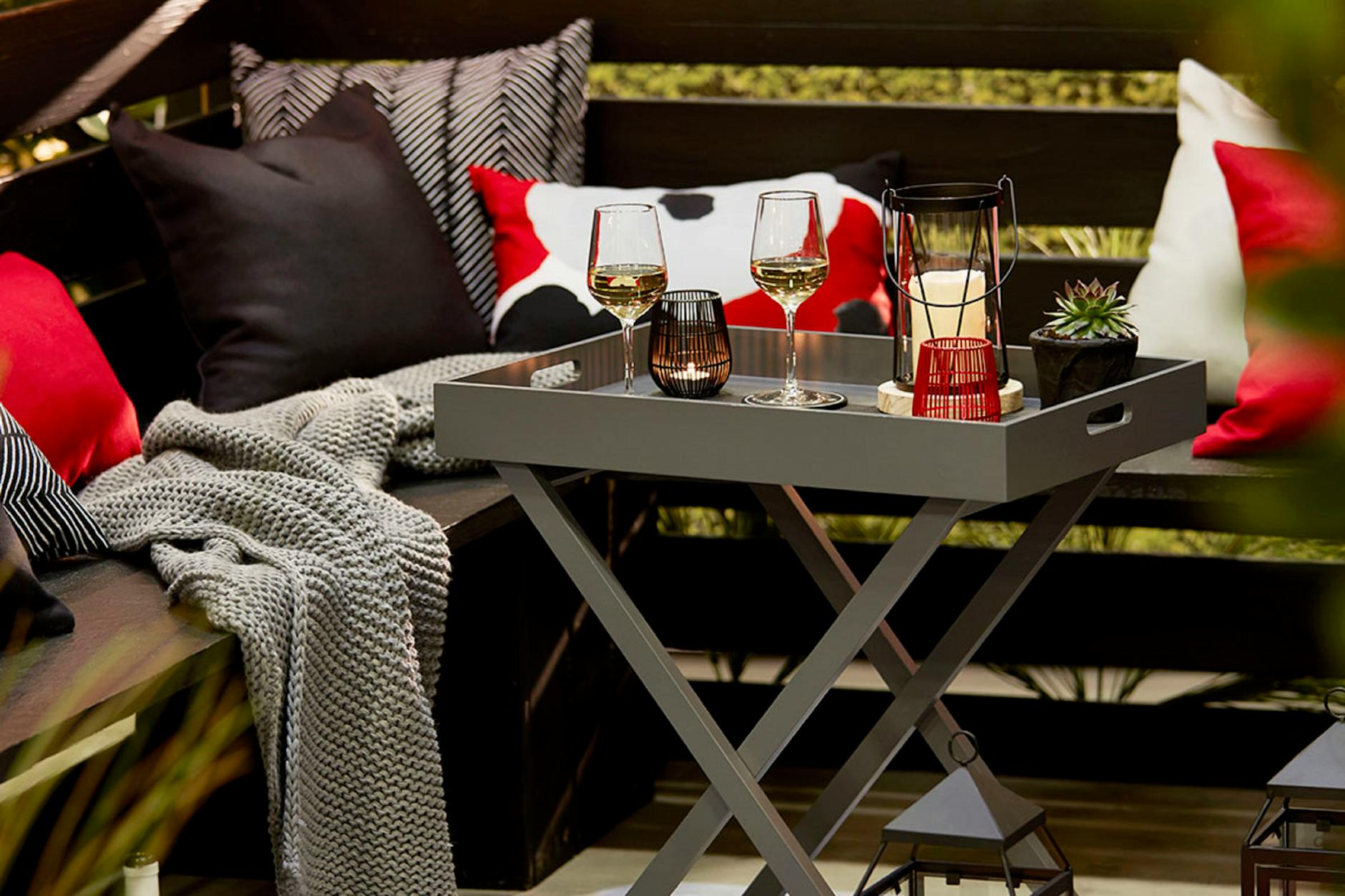 wine glasses on table near pillows The Ultimate Guide to Indoor/Outdoor Living Spaces