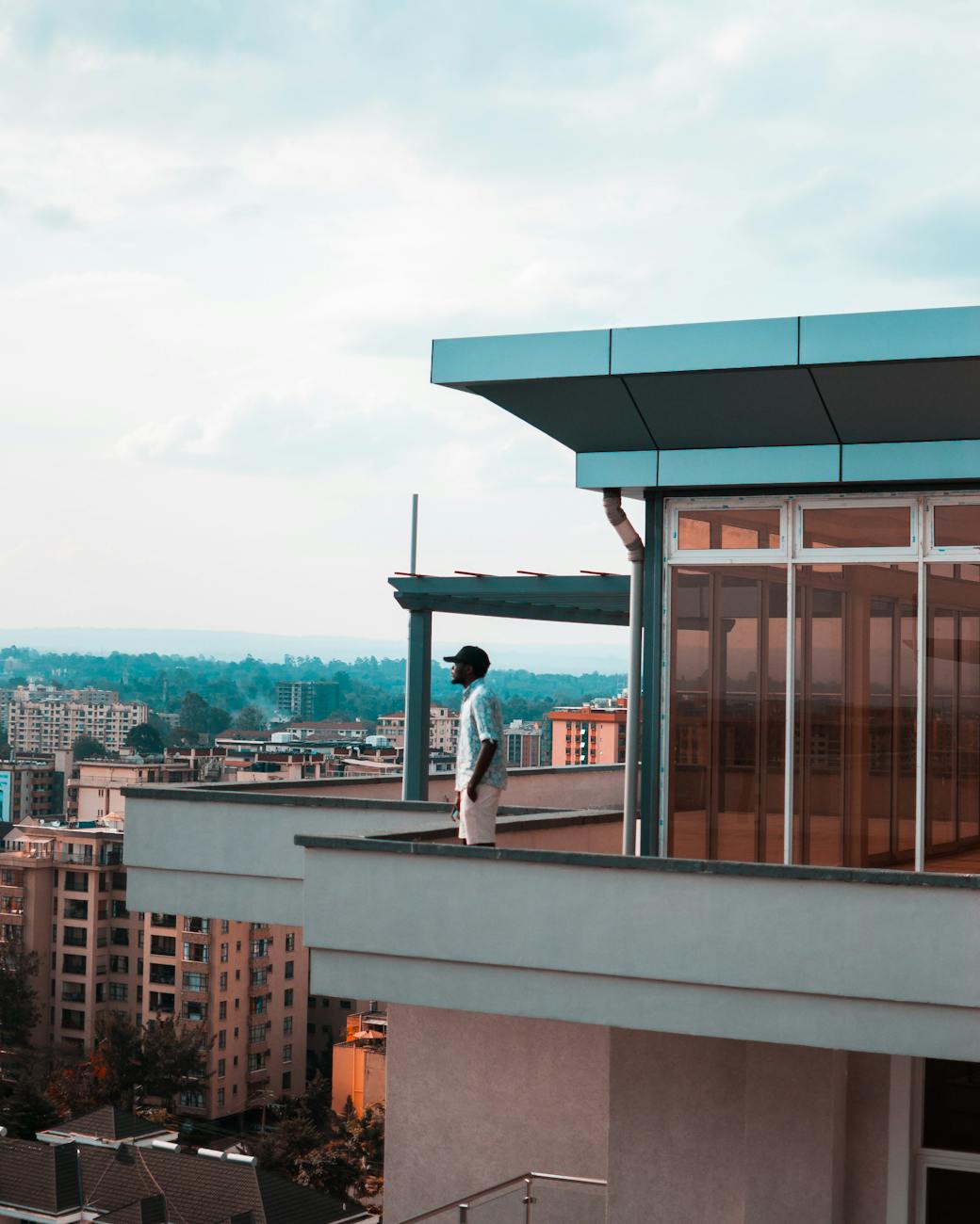 How to Choose the Perfect Location to Invest in Real Estate 10 man standing on balcony How to Choose the Perfect Location to Invest in Real Estate