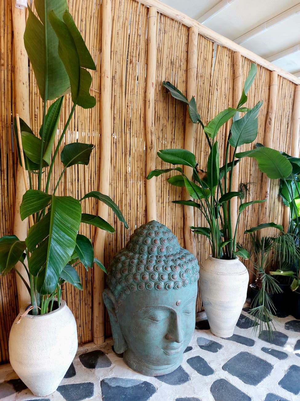 zen garden with buddha sculpture and green plants How to Update Your Outdoor Space on a Budget