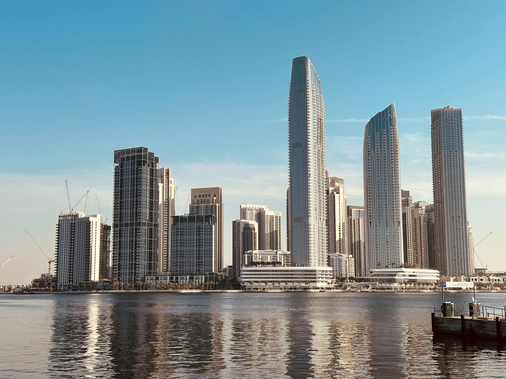 modern skyscrapers reflecting on waterfront Profitable Real Estate Investment Strategies: Tools, Tech, and Resources