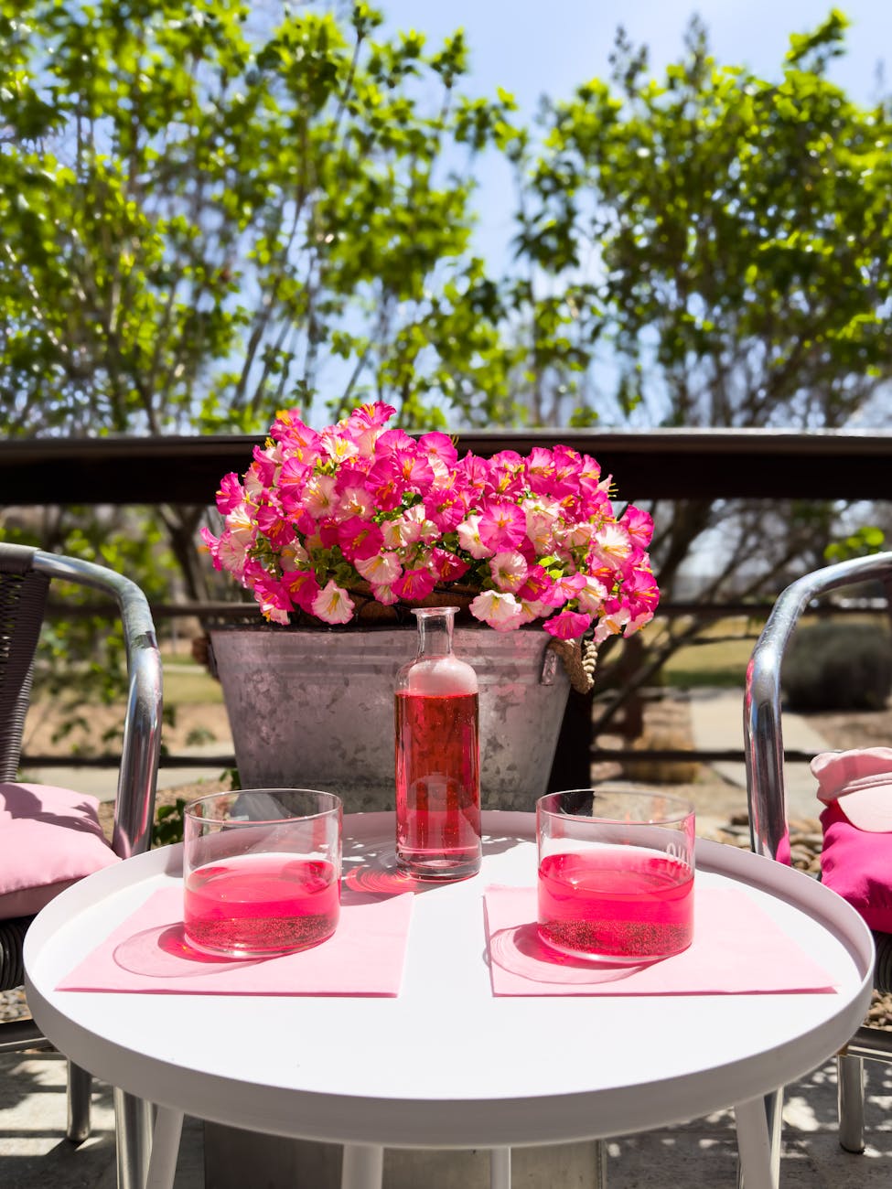 refreshing pink drinks on outdoor patio table How to Update Your Outdoor Space on a Budget