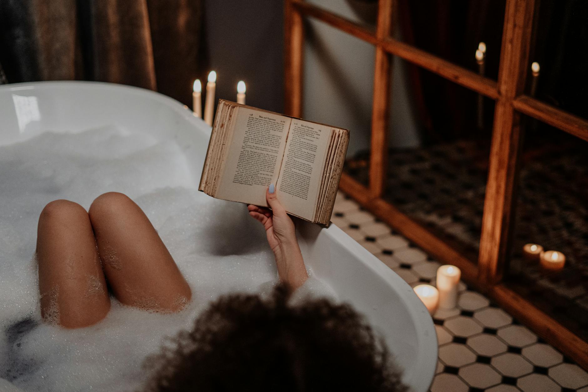 person reading book on bathtub How to Manage Stress When You Hit Rock Bottom