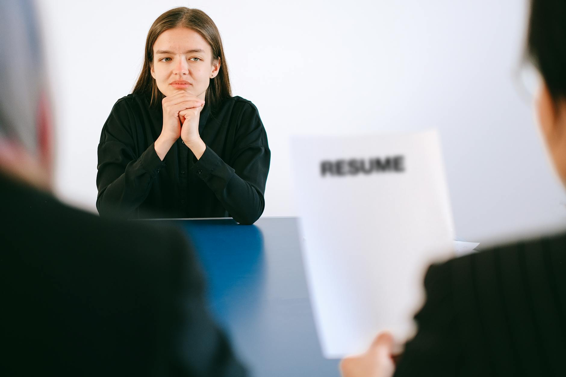 woman in black long sleeve shirt sitting having interview How to Survive When You're Struggling Financially