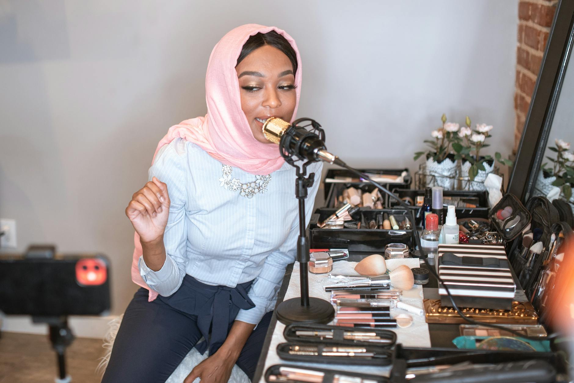 How to Do Influencer Marketing Like a Pro: Crush the Game and Build Your Brand 9 female vlogger in pink hijab using a condenser microphone How to Do Influencer Marketing Like a Pro: Crush the Game and Build Your Brand