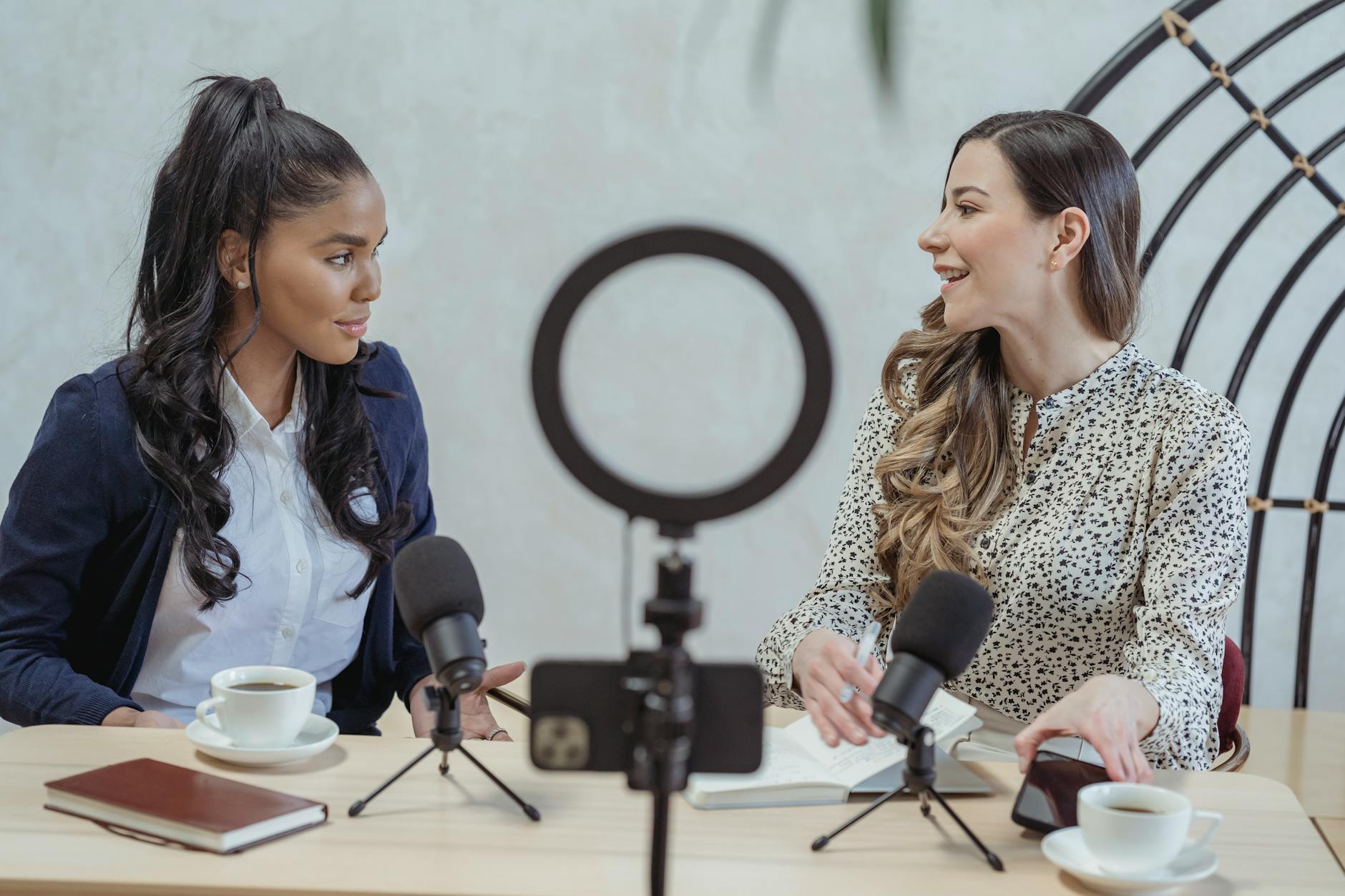 How to Do Influencer Marketing Like a Pro: Crush the Game and Build Your Brand 11 smiling woman interviewing black female guest and recording video How to Do Influencer Marketing Like a Pro: Crush the Game and Build Your Brand