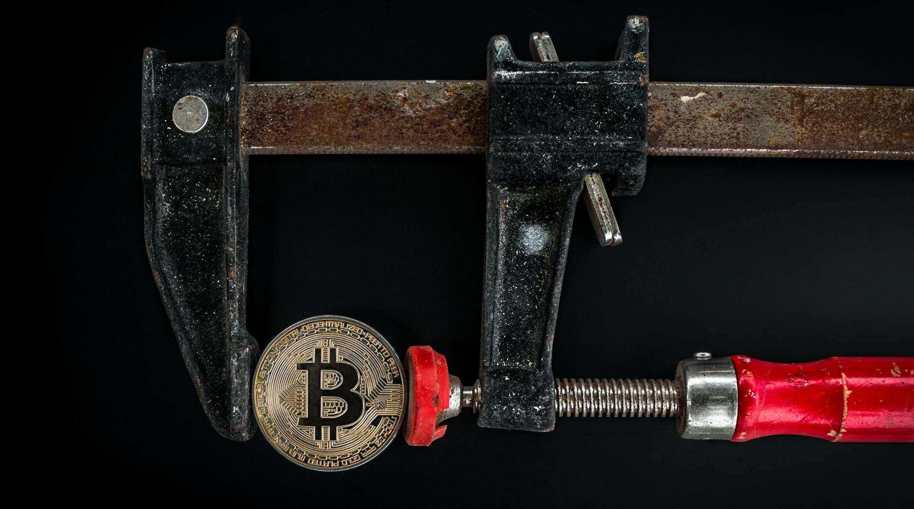 black and red caliper on gold colored bitcoin Challenges of Cryptocurrency Operations in Enterprises and Solutions for Smooth Crypto Integration