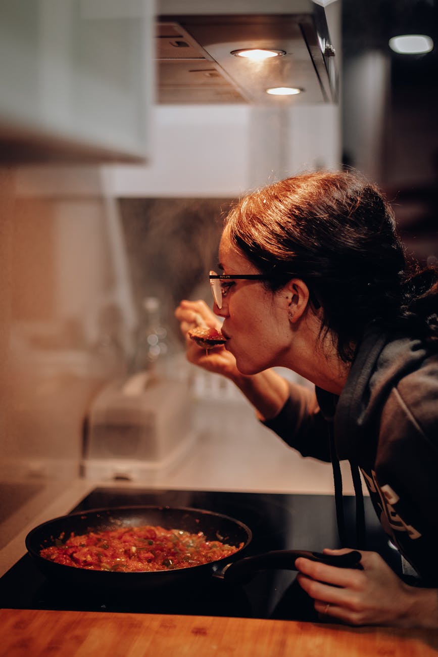 4 Easy Ways to Build Flavor in Home Cooking (Without Overcomplicating Things) 11 woman eating on cooking pan 4 Easy Ways to Build Flavor in Home Cooking (Without Overcomplicating Things)