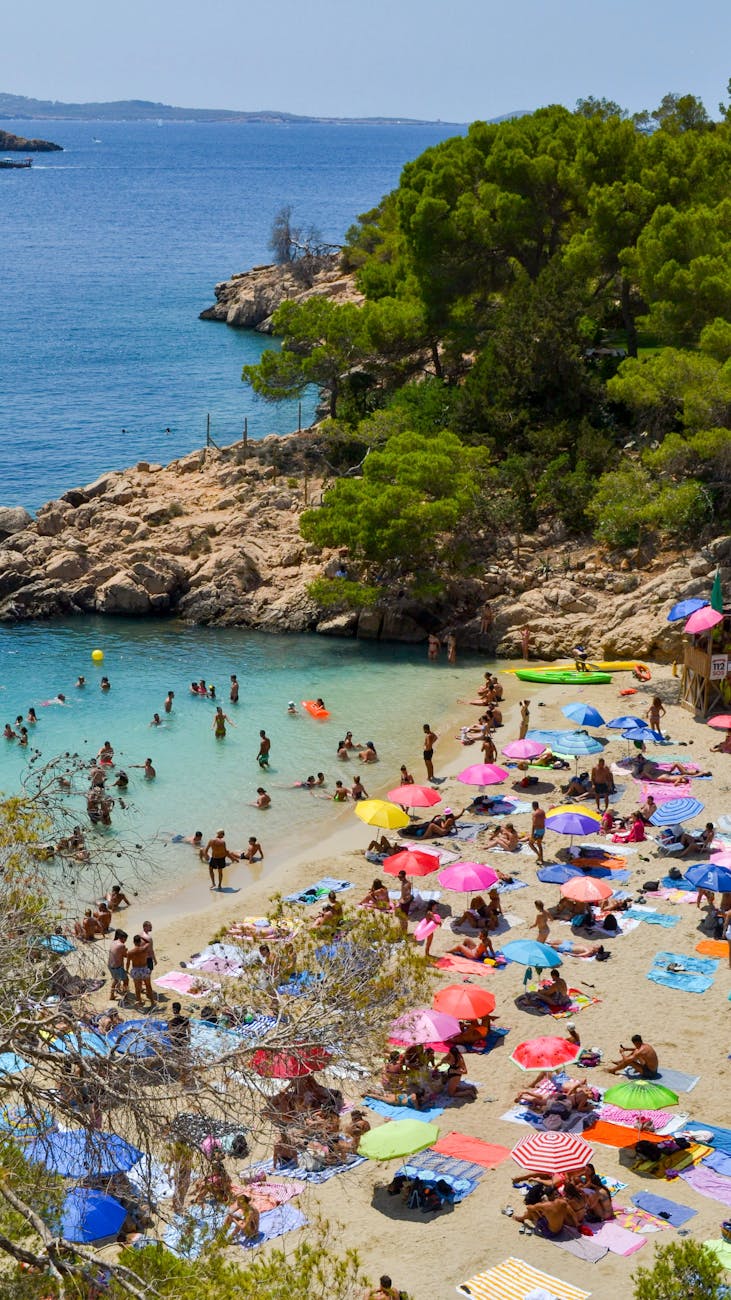 crowded vibrant beach in summer daytime Buying a Home Overseas? Practical Tips for a Smart Purchase