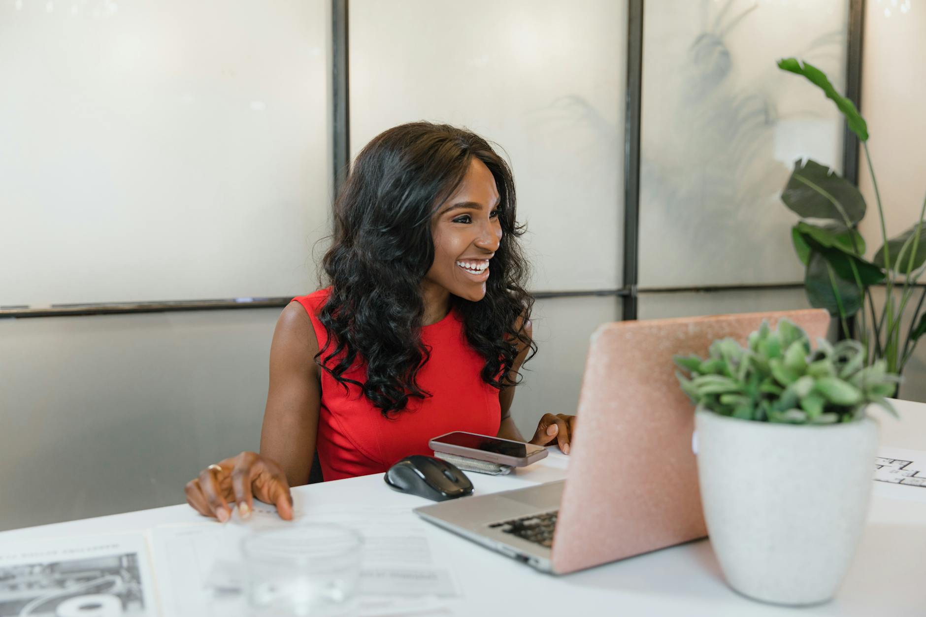 woman in dress sitting in front of a laptop