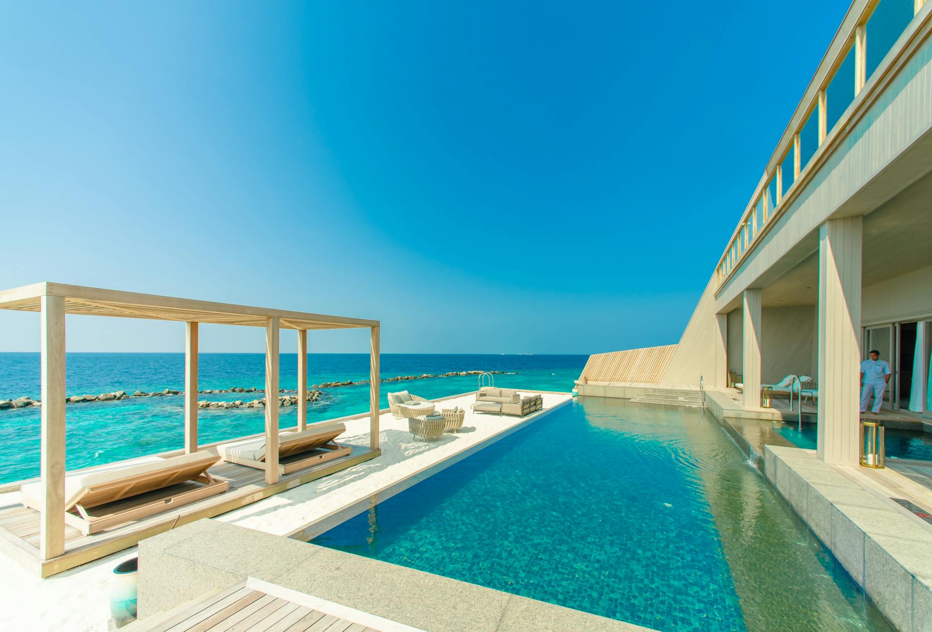 6 Ways to Add Luxury to Your Next Vacation 7 architectural photography of gray granite swimming pool and outdoor lounge at beach side Add Luxury to Your Next Vacation