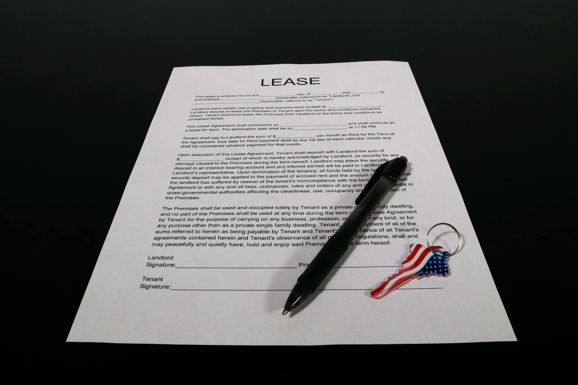 lease agreement document with pen and keychain Landlord Diaries: Is Passive Income Ever Really Passive?