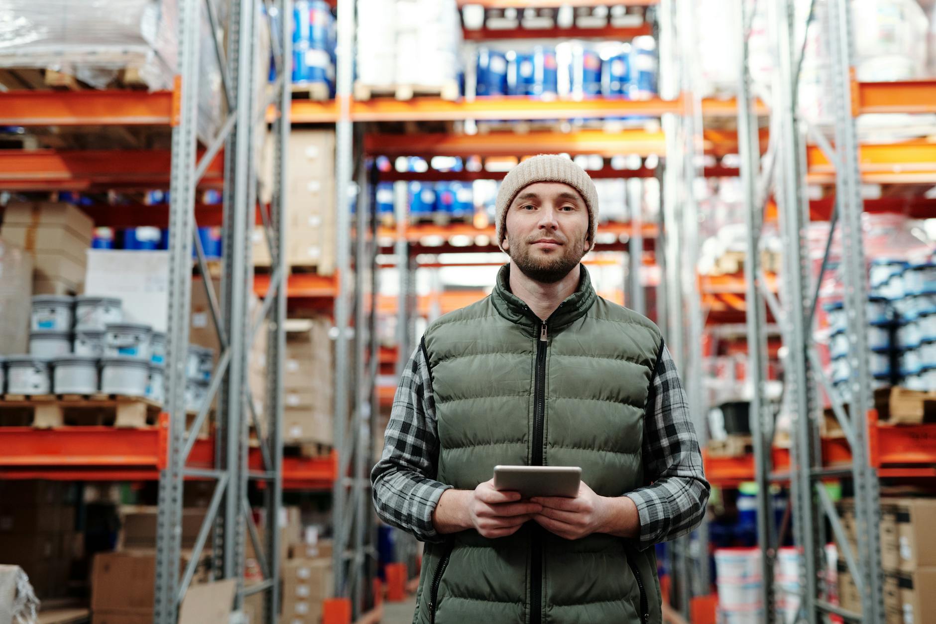 man in bubble jacket holding tablet computer Signs You're Ready To Expand Your Business