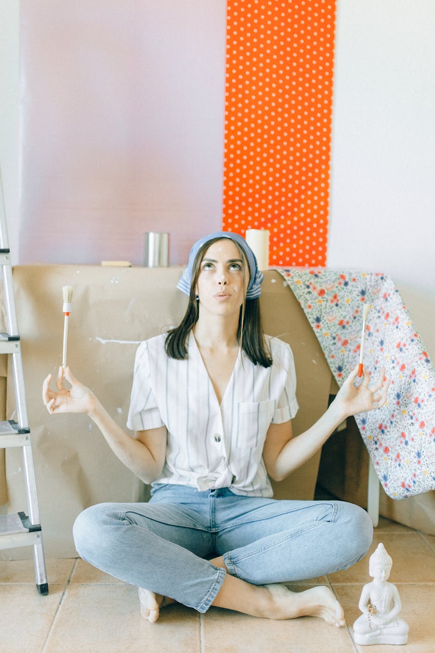 woman in white button up shirt and blue denim jeans sitting on white and red polka How to Survive Renovating Your Home (Without Losing Your Mind as a Working Mom)