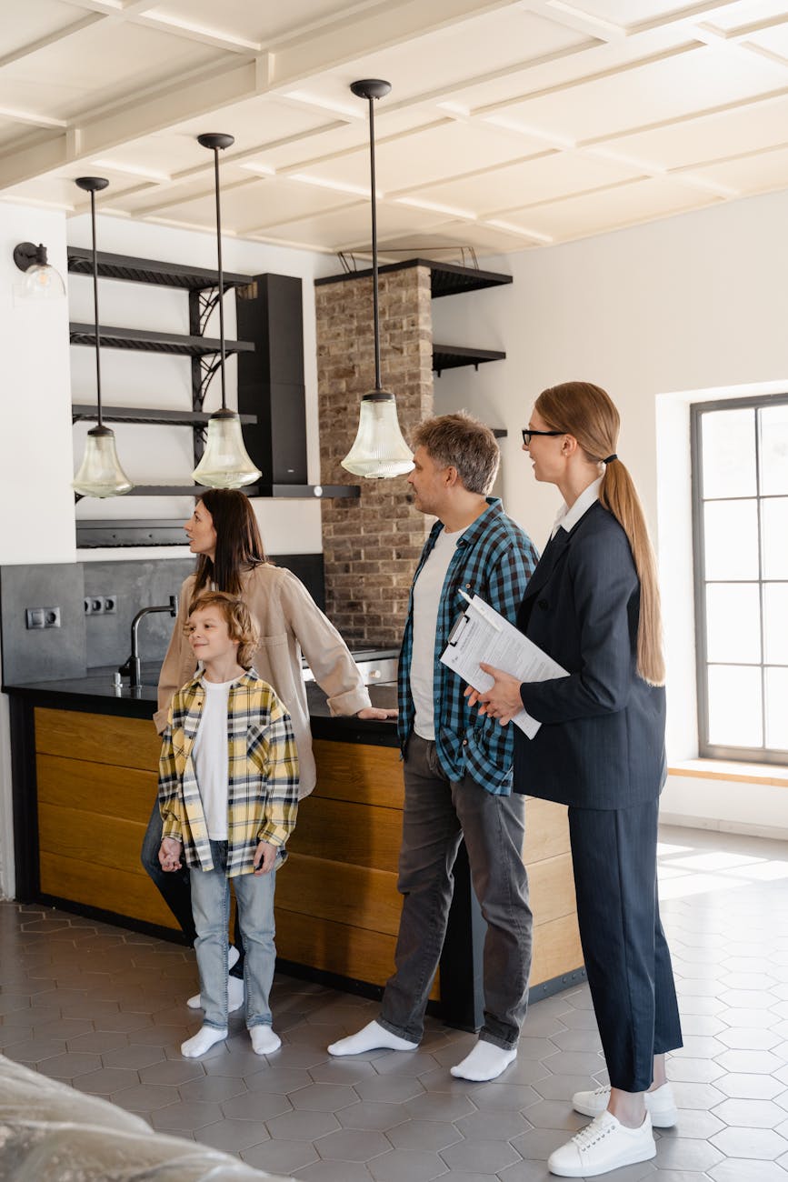 a family with a real estate agent Buying A Home In Five Easy Steps