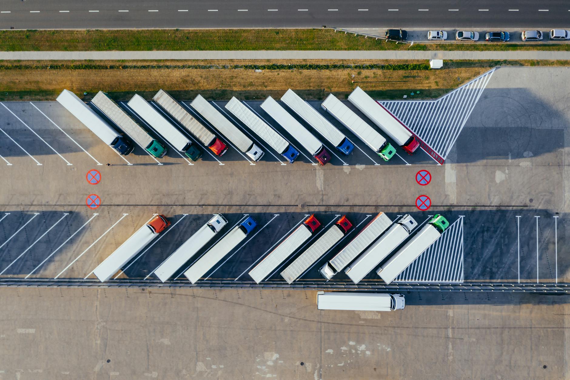 aerial photography of trucks parked The Pros And Cons Of Becoming A Truck Driver