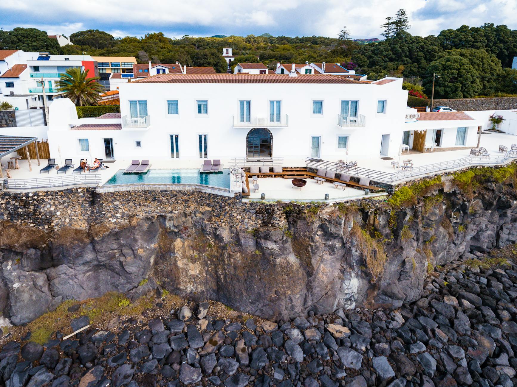 What Makes a Market “Elite”: High-End Vacation Rental Investment Hubs 9 white and brown concrete building on a cliff What Makes a Market “Elite”: High-End Vacation Rental Investment Hubs
