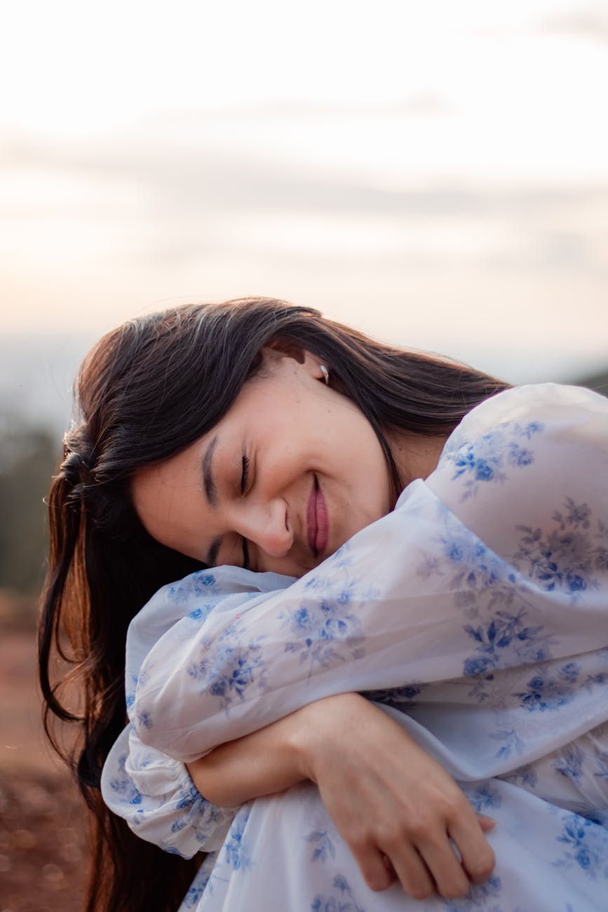 serene woman smiling outdoors at sunset What to Do When You’re Feeling Unfulfilled