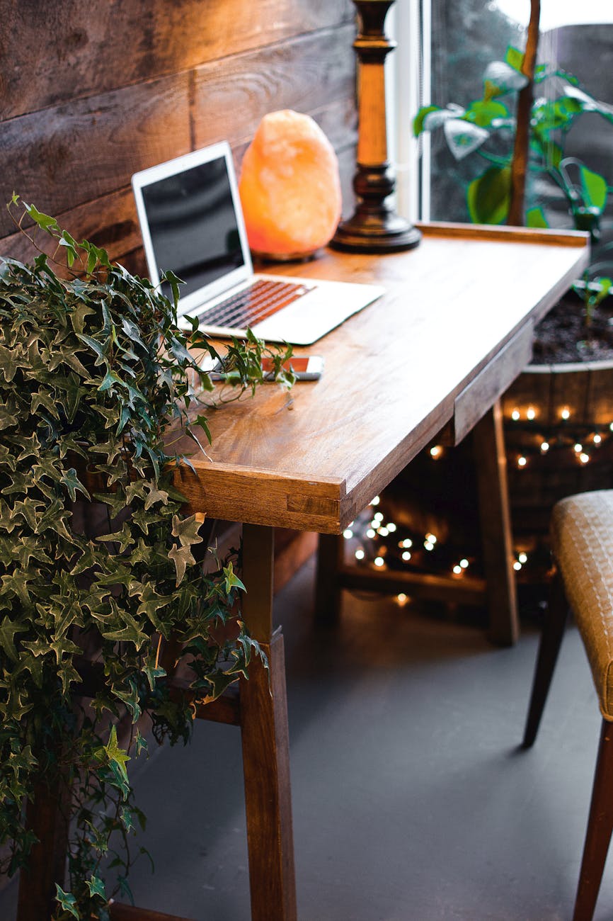 himalayan salt lamp near laptop on wooden table Office Perks that Work for Every Generation on Your Team