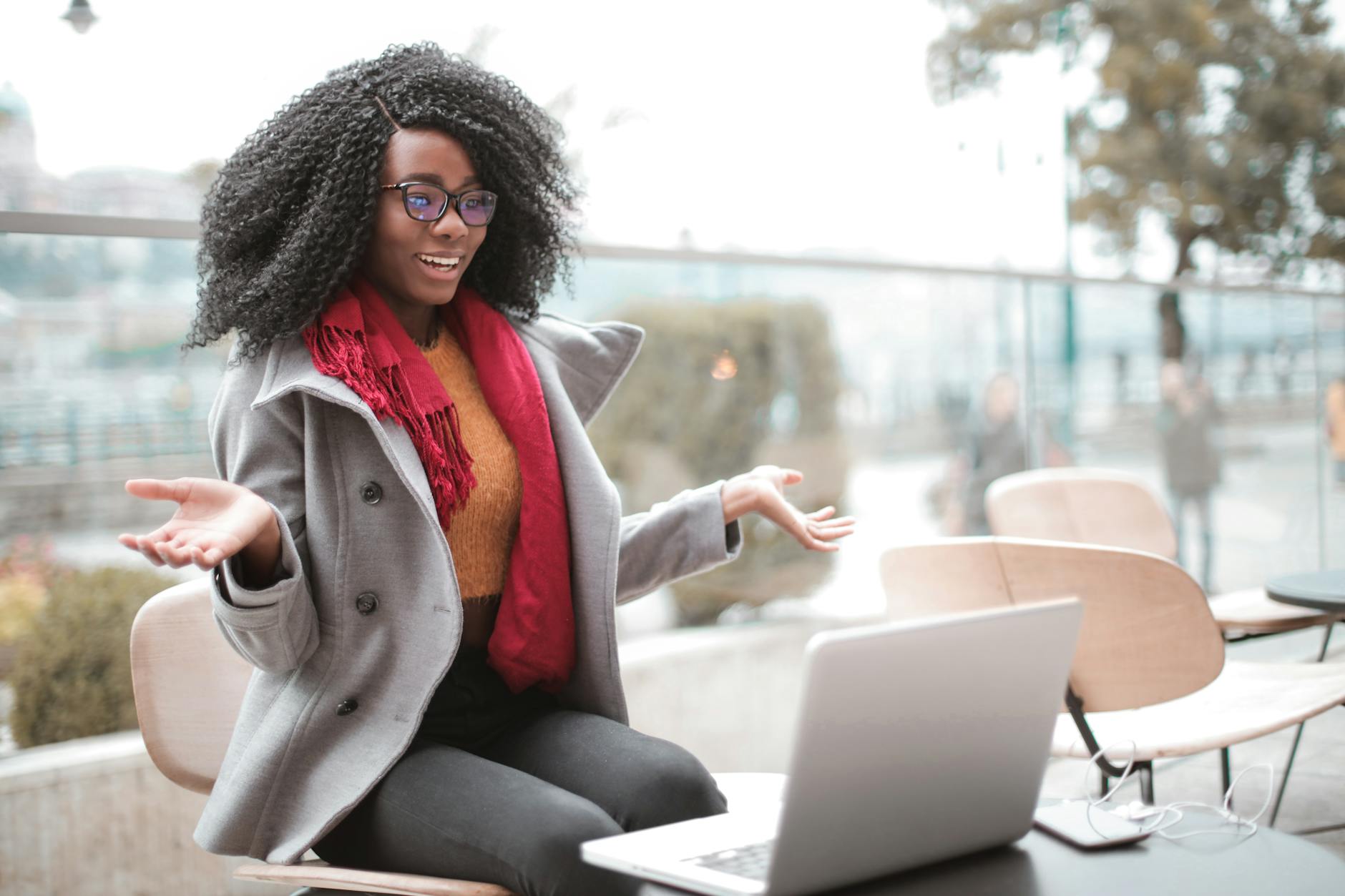cheerful surprised woman sitting with laptop Why Virtual Meetings Are a Game-Changer for Real Estate Efficiency