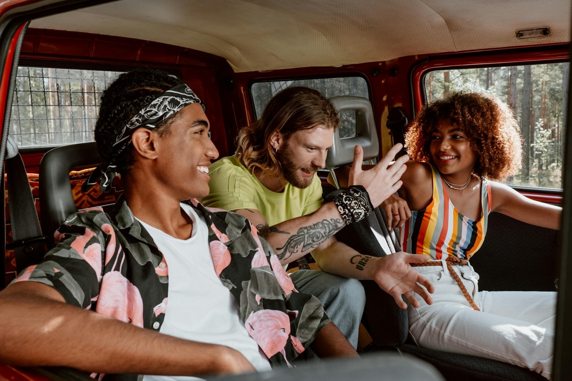 group of friends sitting inside a vehicle while having a conversation