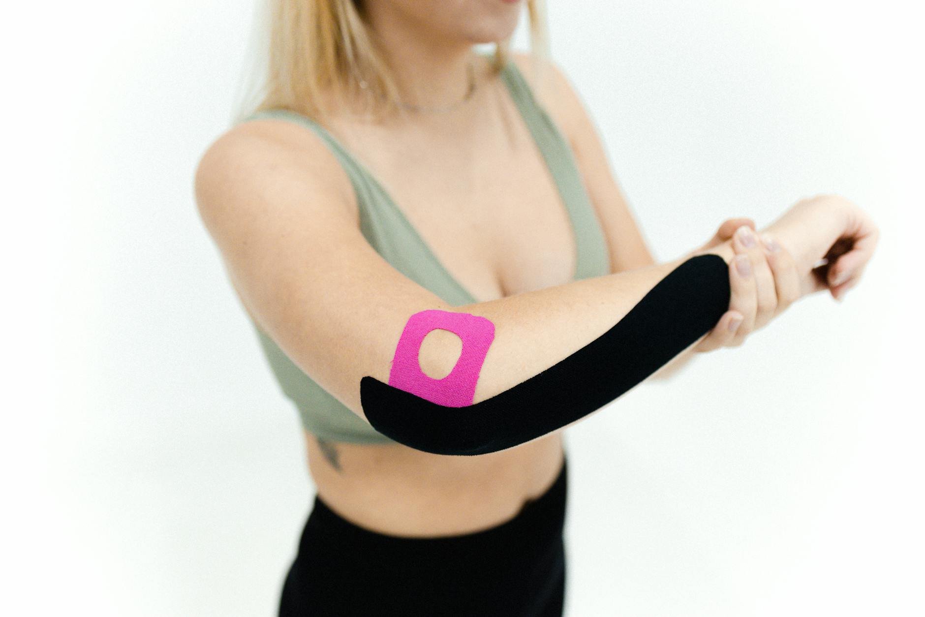a woman with kinesio tapes on her back arm Fracture vs Sprain–Do You Have Broken A Bone?
