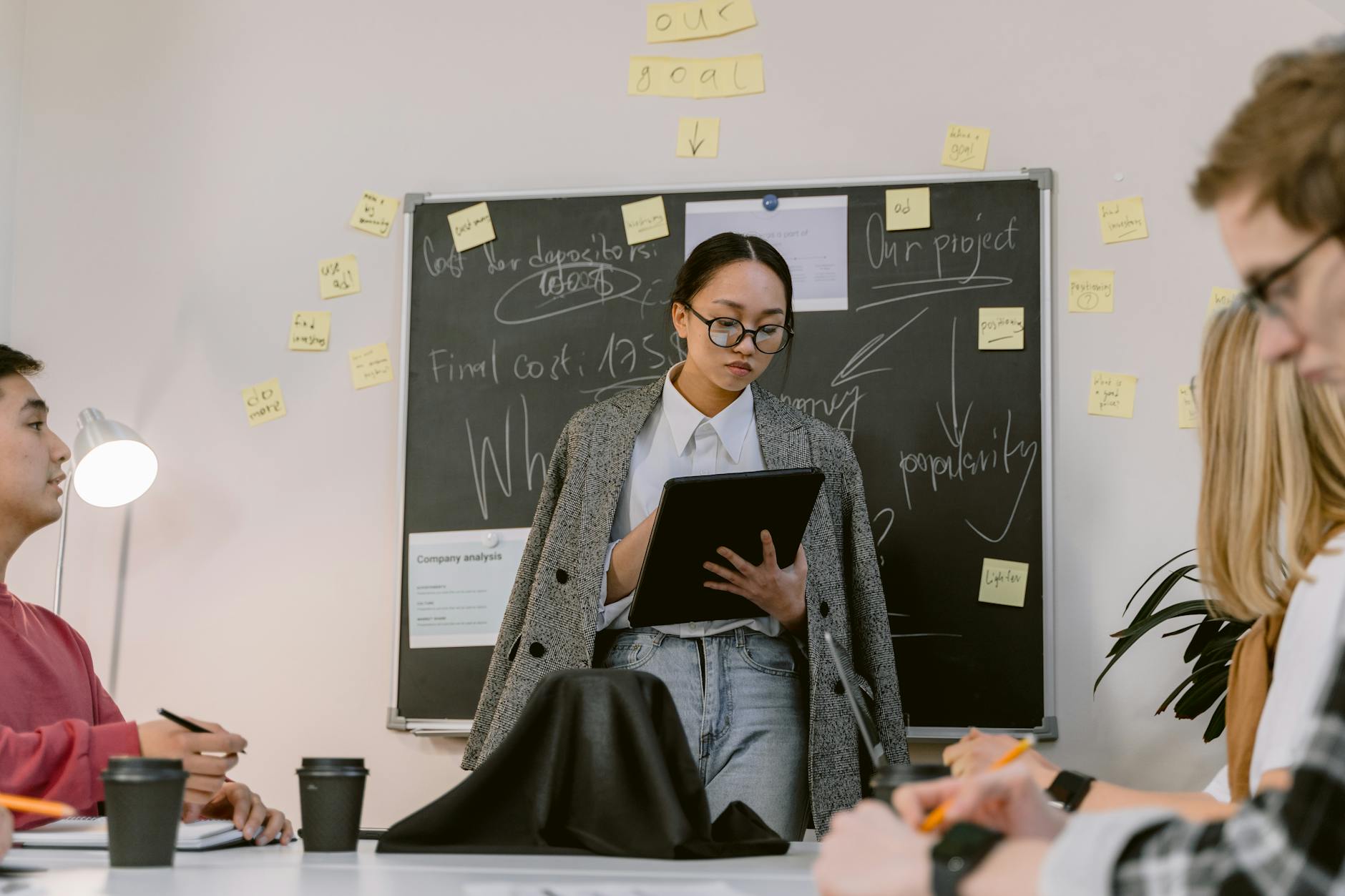 woman holding a tablet at the meeting 4 Important Aspects Of Running A Successful Business