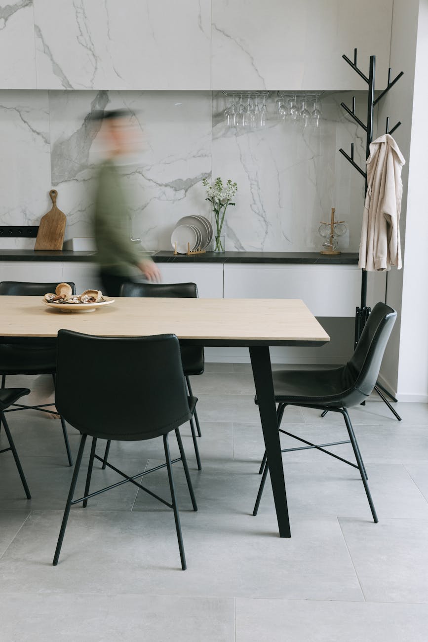 brown wooden table with black chairs How Custom Table Bases Elevate Dining Room Aesthetics