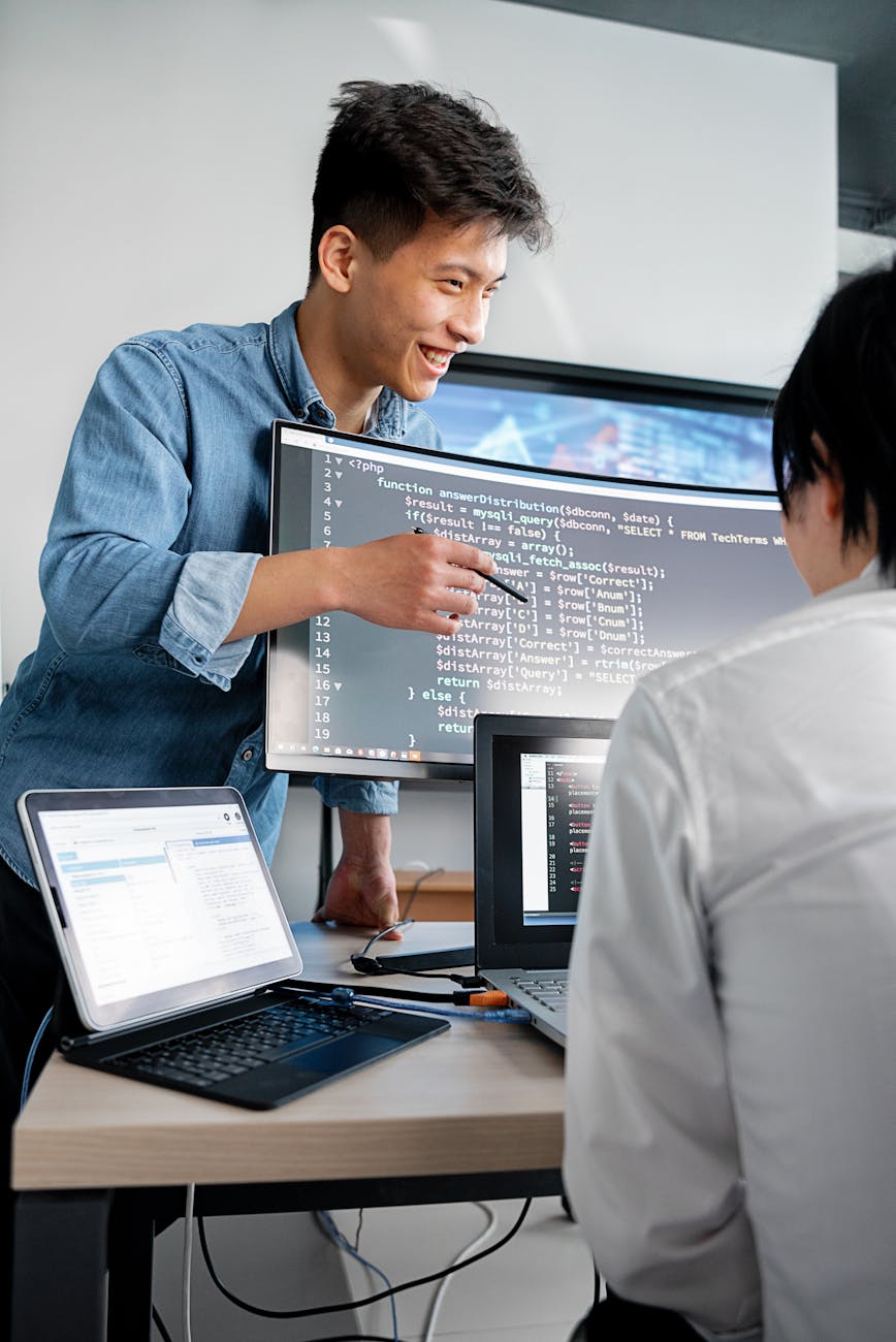 3 Essential Tips to Run a Successful Business & Make a Profit 8 a man in gray denim long sleeves pointing the codes on the monitor 3 Essential Tips to Run a Successful Business & Make a Profit