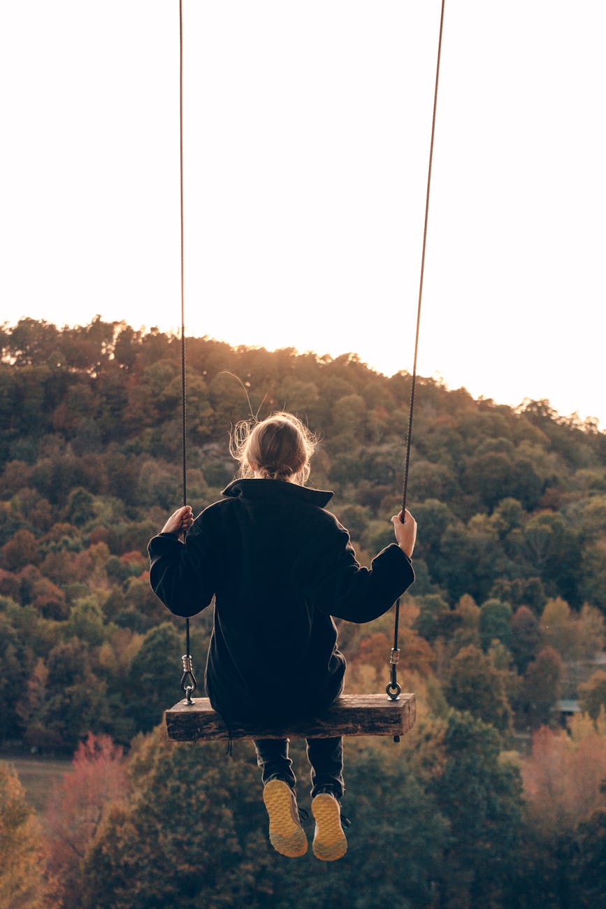 woman in black hoodie sitting on swing 5 Best Places to Buy Affordable Rural Land in the U.S. Reviewed 2025
