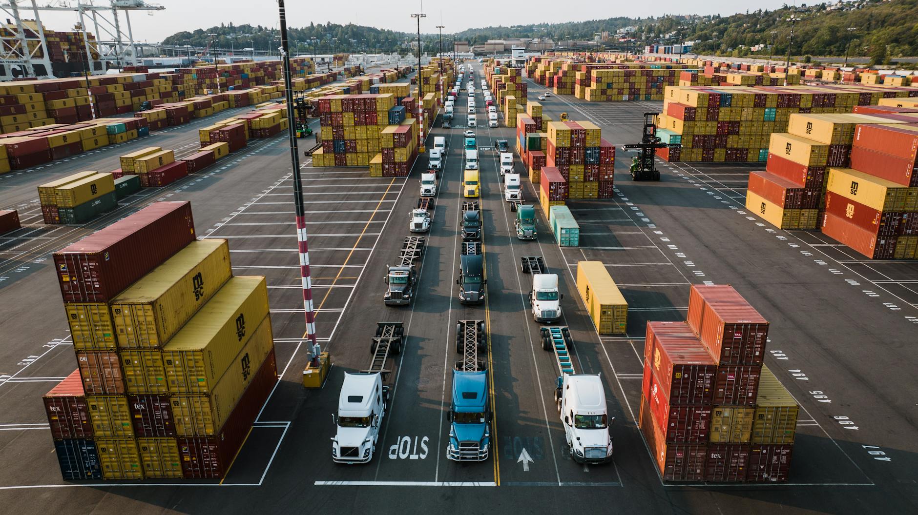 parked trucks and cargo containers on port Are You Cut Out to be a Truck Driver? A Realistic Look at the Career