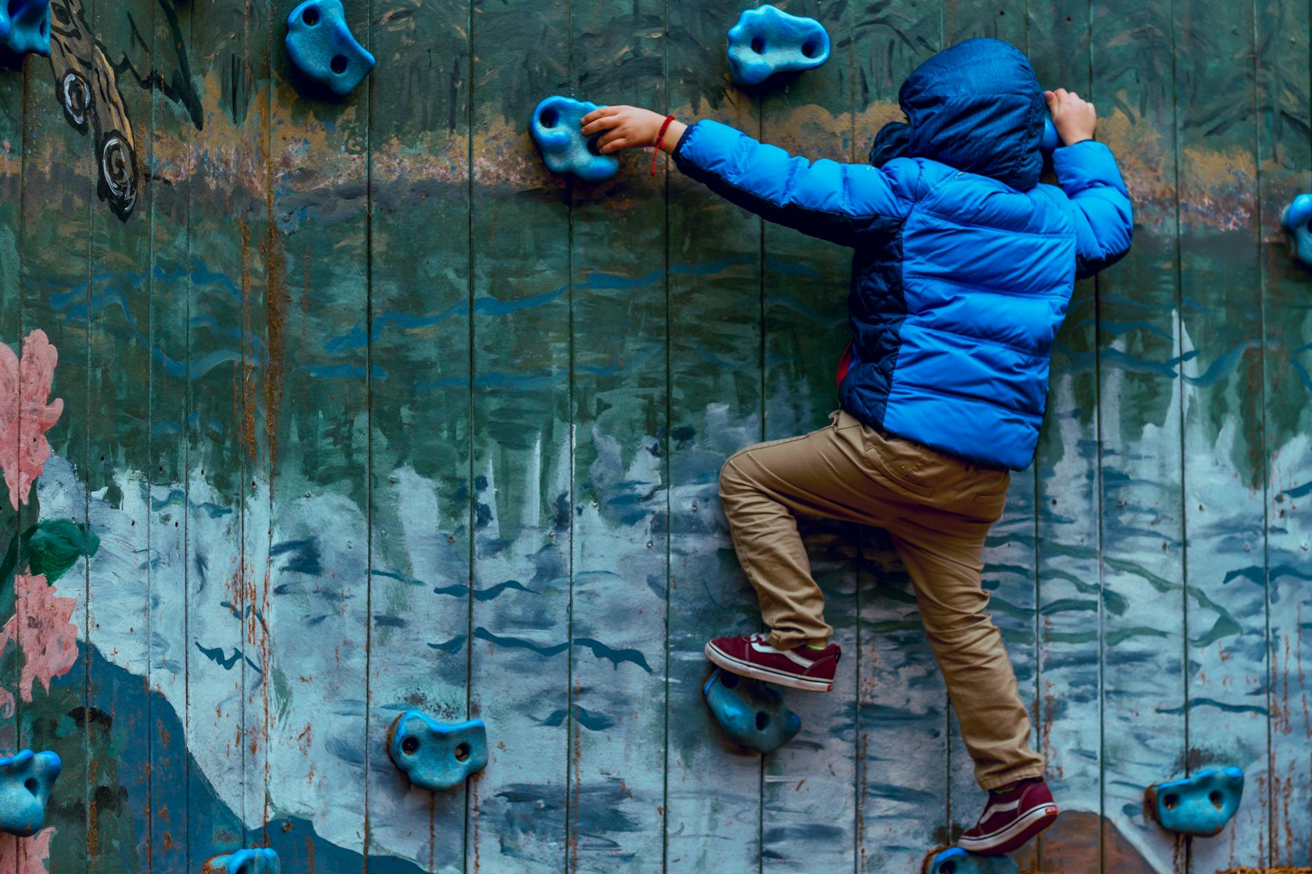 photo of boy wall climbing How to Make Your Garden Fun and Kid-Friendly