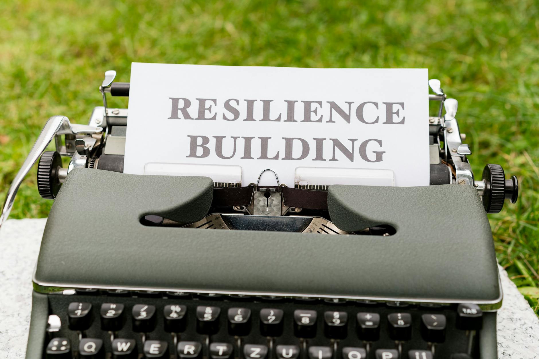a typewriter with a paper that says resilience building https://modernfrontierswoman.com/the-role-of-workplace-safety-in-driving-business-success/